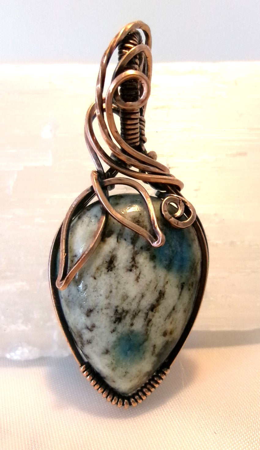 K-2 stone copper wire wrapped crystal pendant with leaf and spiral detail