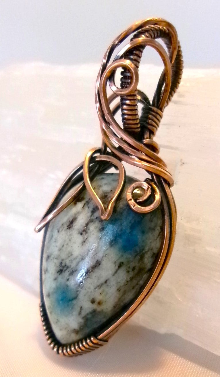 K-2 stone copper wire wrapped crystal pendant with leaf and spiral detail