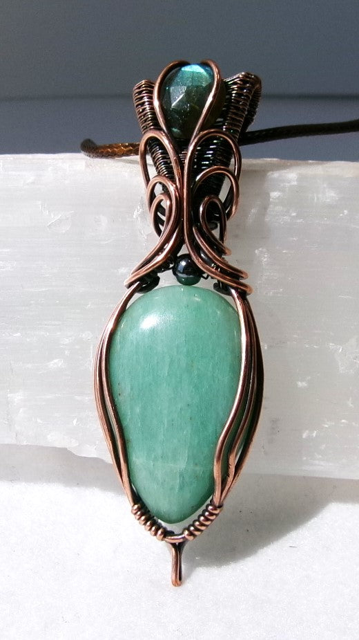 Amazonite gemstone copper wire wrapped crystal pendant with a blue-green faceted labradorite gemstone set in a woven bail and a hematite accent bead