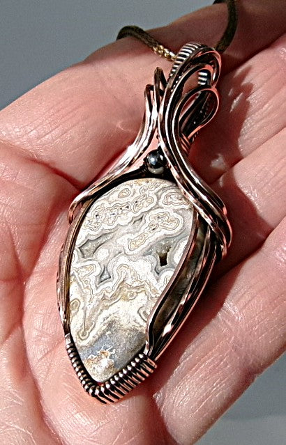 Crazy Lace Agate gemstone copper wire wrapped crystal pendant with a hematite accent bead