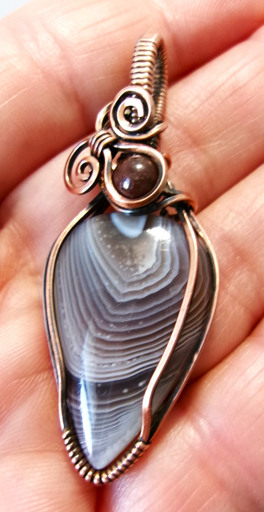 Botswana Agate gemstone copper wire wrapped crystal pendant with garnet accent bead and 2 spirals