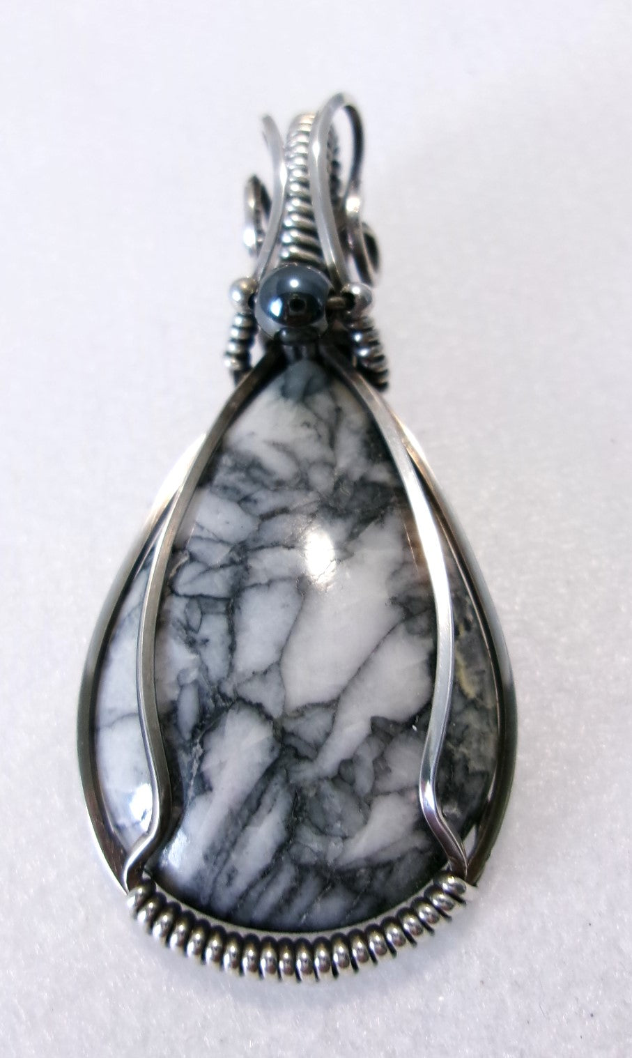 Pinolith gemstone sterling silver wire wrapped crystal pendant with hematite and sterling silver accent beads