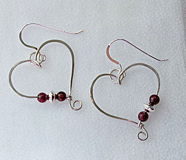 Red garnet sterling silver wire earrings in a heart shape design with a tiny spiral