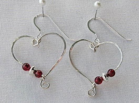 Red garnet sterling silver wire earrings in a heart shape design with a tiny spiral