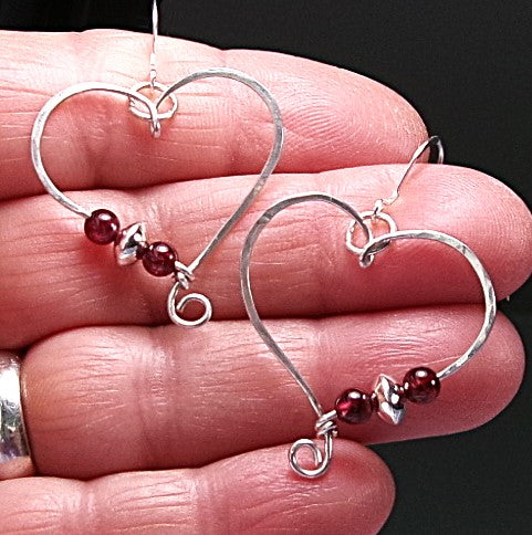 Red garnet sterling silver wire earrings in a heart shape design with a tiny spiral