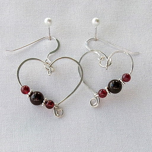 Red garnet sterling silver wire earrings in a heart shape design with a tiny spiral