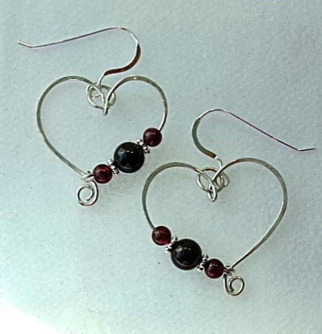 Red garnet sterling silver wire earrings in a heart shape design with a tiny spiral
