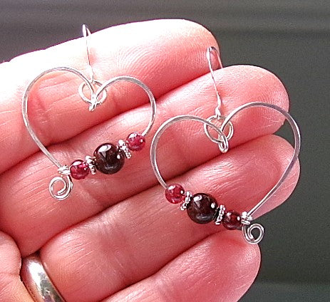 Red garnet sterling silver wire earrings in a heart shape design with a tiny spiral