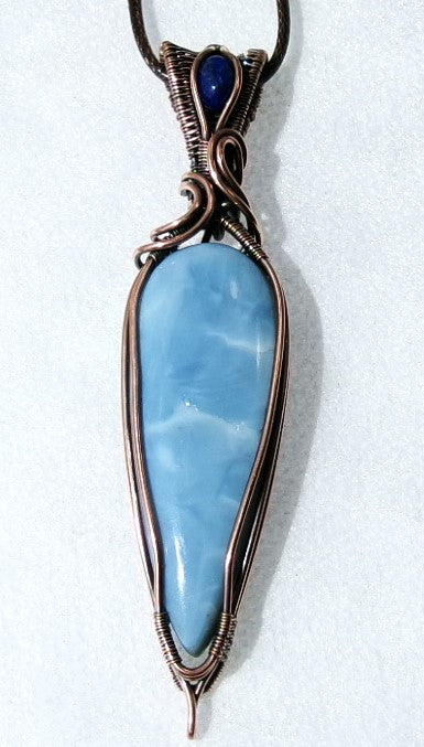 Owyhee Blue Opal gemstone copper wire wrapped crystal pendant with lapis lazuli gemstone set in a woven bail