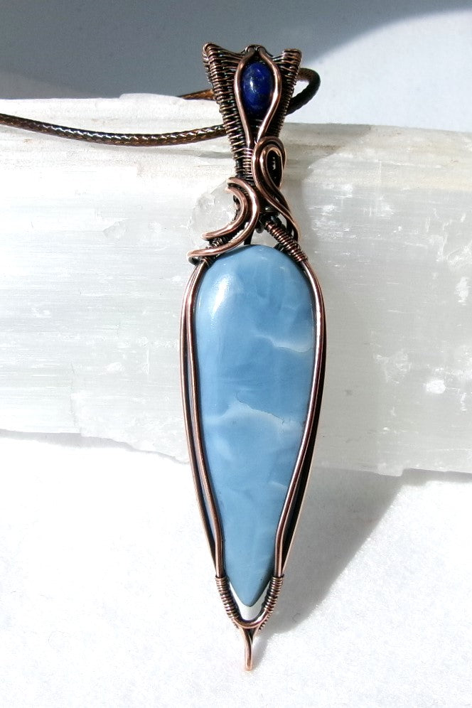 Owyhee Blue Opal gemstone copper wire wrapped crystal pendant with lapis lazuli gemstone set in a woven bail