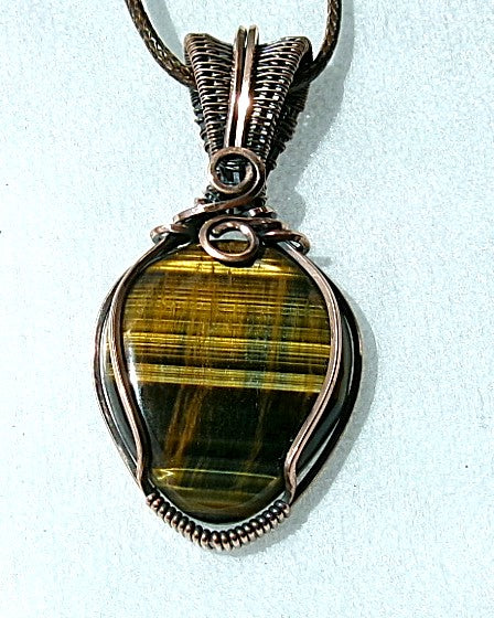 Blue Tiger’s Eye gemstone copper wire wrapped crystal pendant with a woven bail and swirls