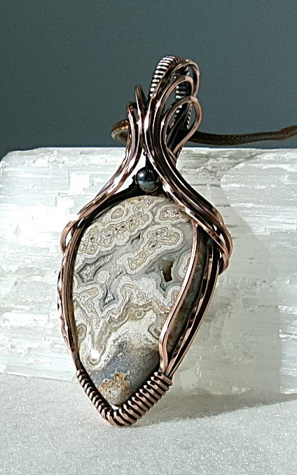 Crazy Lace Agate gemstone copper wire wrapped crystal pendant with a hematite accent bead