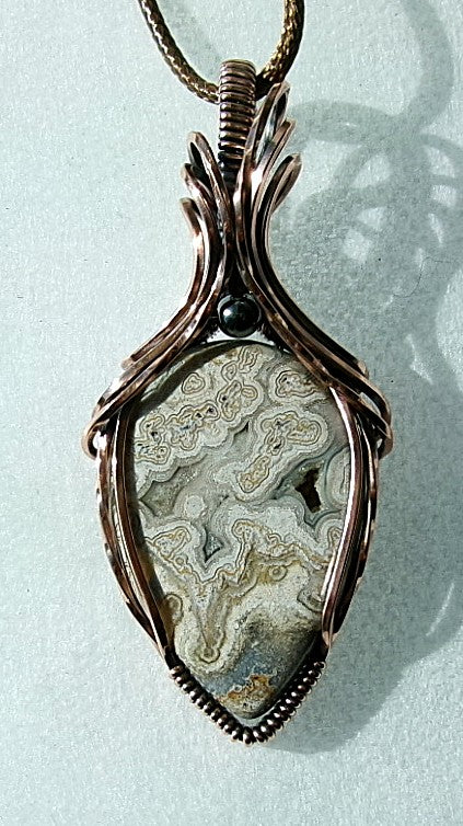 Crazy Lace Agate gemstone copper wire wrapped crystal pendant with a hematite accent bead