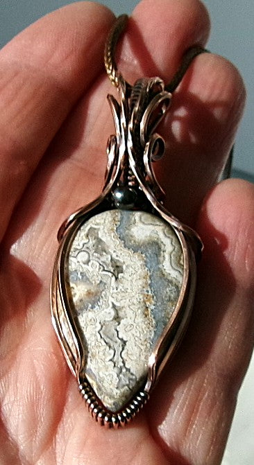 Crazy Lace Agate gemstone copper wire wrapped crystal pendant with a hematite accent bead