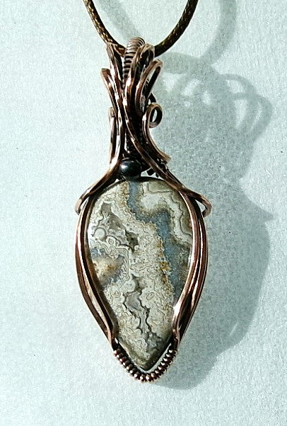 Crazy Lace Agate gemstone copper wire wrapped crystal pendant with a hematite accent bead