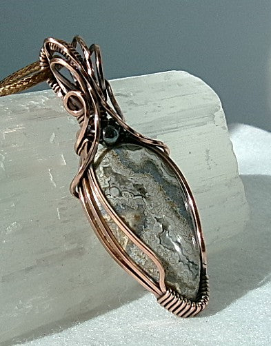 Crazy Lace Agate gemstone copper wire wrapped crystal pendant with a hematite accent bead