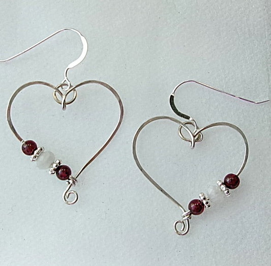 Red garnet and moonstone sterling silver wire earrings in a heart shape design with a tiny spiral