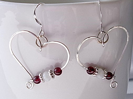 Red garnet and moonstone sterling silver wire earrings in a heart shape design with a tiny spiral