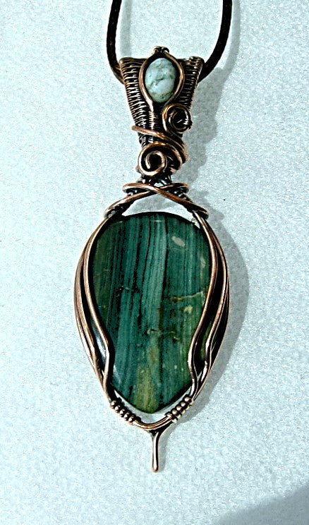 Gary Green Jasper gemstone copper wire wrapped crystal pendant with a woven bail that contains a tree agate gemstone