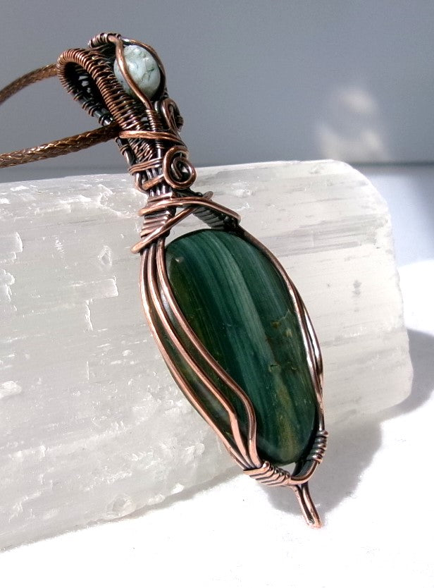Gary Green Jasper gemstone copper wire wrapped crystal pendant with a woven bail that contains a tree agate gemstone