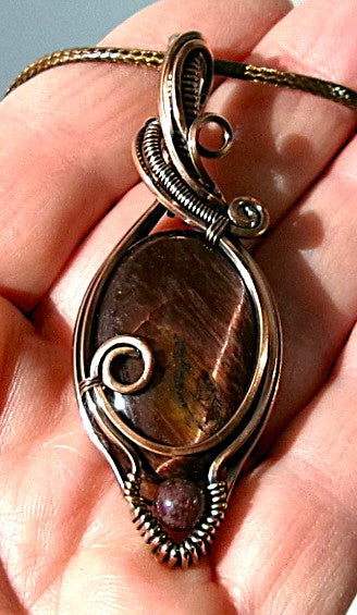 Red Tiger’s Eye gemstone copper wire wrapped crystal pendant with red garnet accent bead