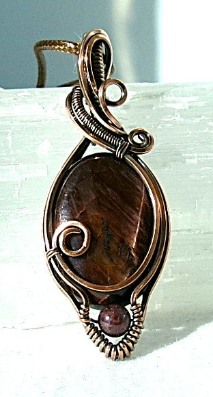 Red Tiger’s Eye gemstone copper wire wrapped crystal pendant with red garnet accent bead