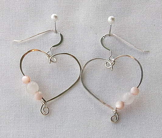 Rose quartz and pink shell sterling silver wire earrings in a heart shape design with a tiny spiral