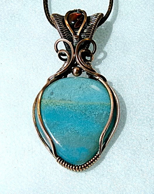 Trolleite gemstone copper wire wrapped crystal pendant with red tiger’s eye gemstone set in a woven bail with copper accent bead