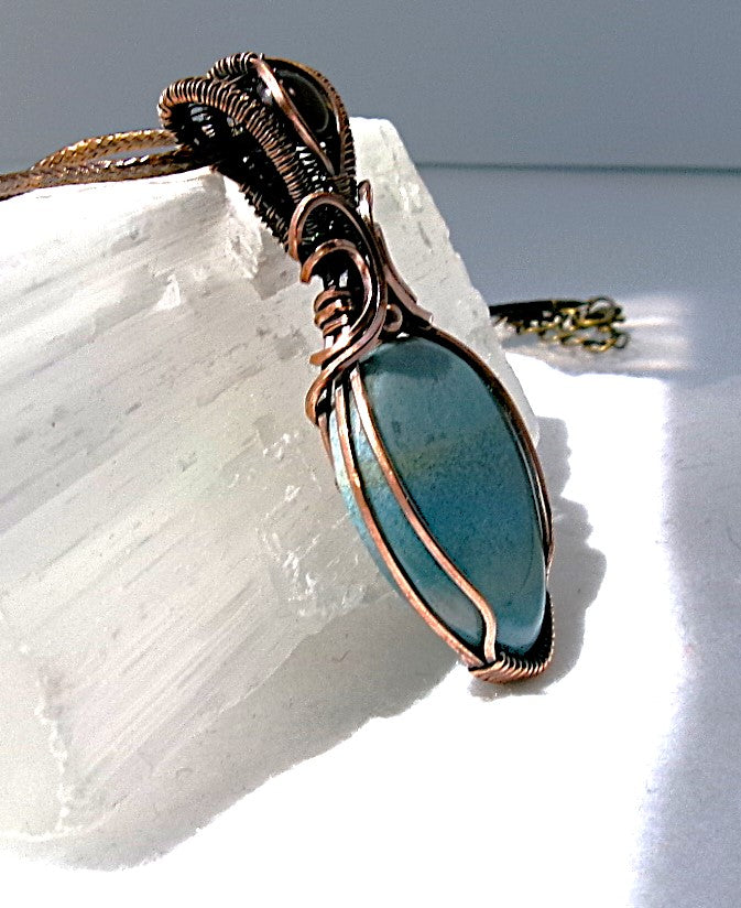 Trolleite gemstone copper wire wrapped crystal pendant with red tiger’s eye gemstone set in a woven bail with copper accent bead